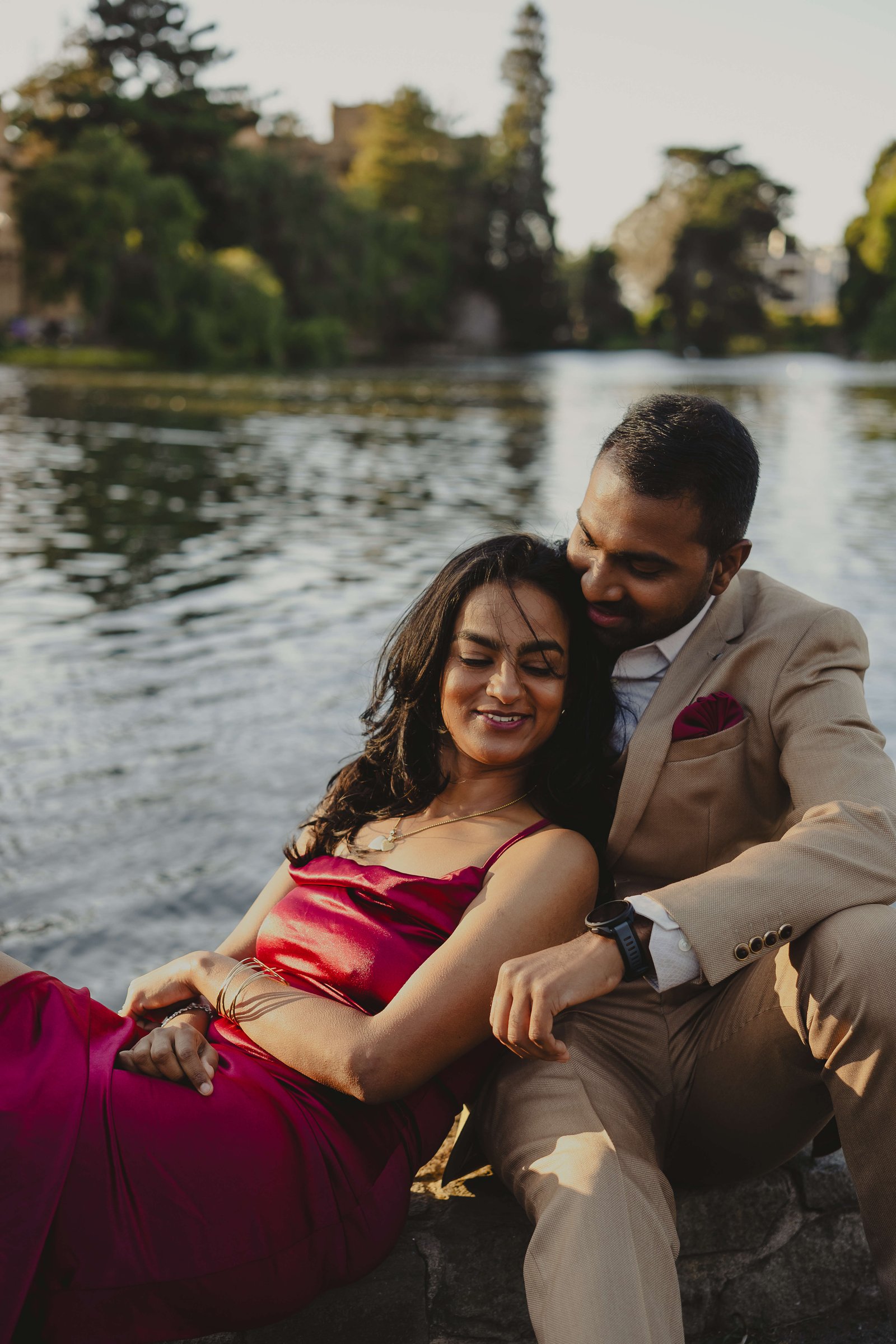 A candid embrace beside the water